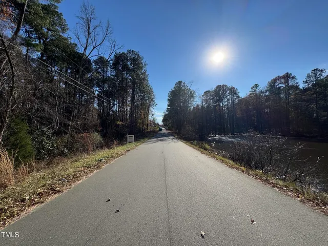 a view of a house with a yard and tree s