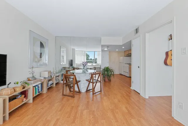 a view of a dining room with furniture and wooden floor