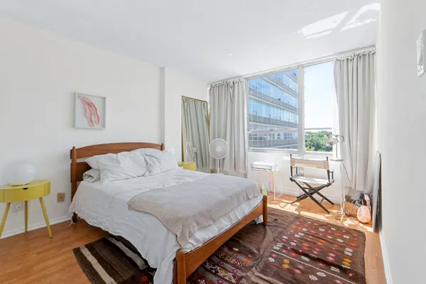 a bedroom with a bed and wooden floor