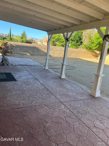 a view of a hallway with wooden shelves