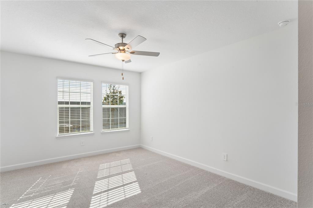 6692 Homebound Way New Port Richey, FL 34653 - Photo 20 of 47 an empty room with windows and fan