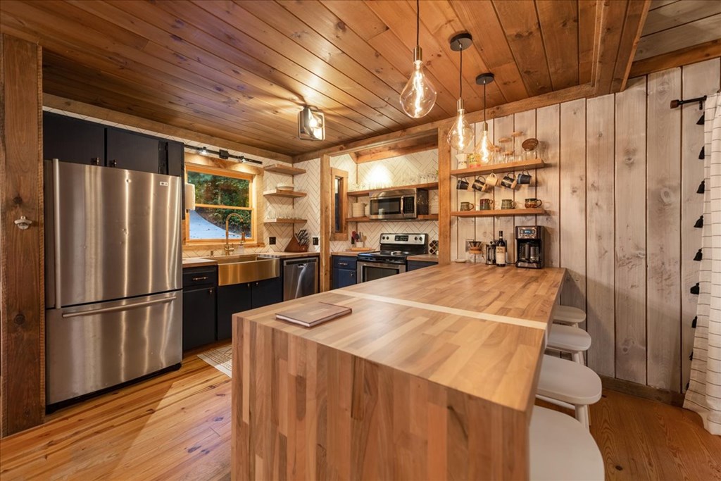 126 Brookwood Drive Blue Ridge, GA 30513 - Photo 32 of 84 a kitchen with stainless steel appliances a refrigerator and a stove top oven