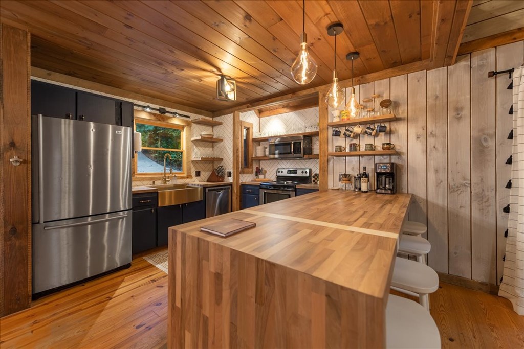 126 Brookwood Drive Blue Ridge, GA 30513 - Photo 33 of 84 a kitchen with stainless steel appliances a refrigerator and a stove top oven