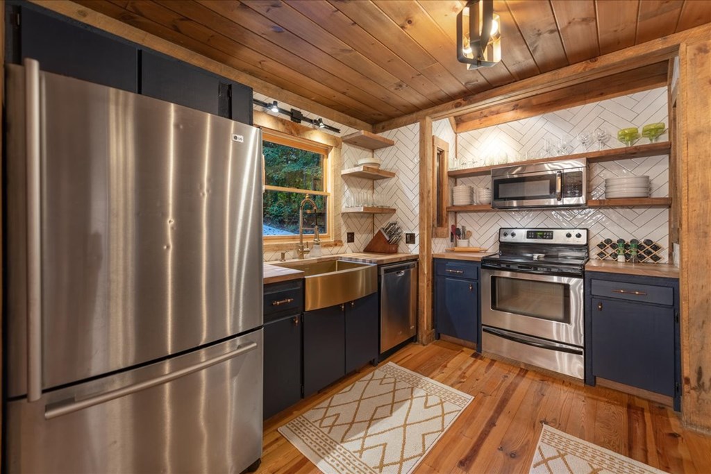 126 Brookwood Drive Blue Ridge, GA 30513 - Photo 34 of 84 a kitchen with stainless steel appliances granite countertop a refrigerator a sink dishwasher a stove and a refrigerator with wooden floor