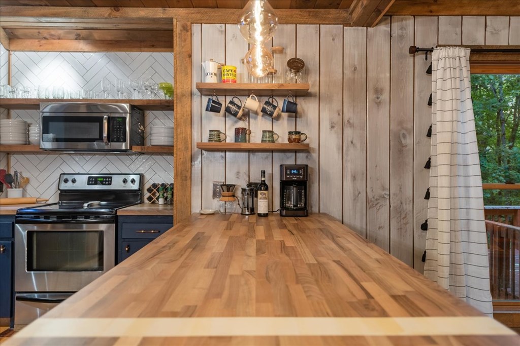 126 Brookwood Drive Blue Ridge, GA 30513 - Photo 37 of 84 a open kitchen with stainless steel appliances granite countertop a stove and a refrigerator