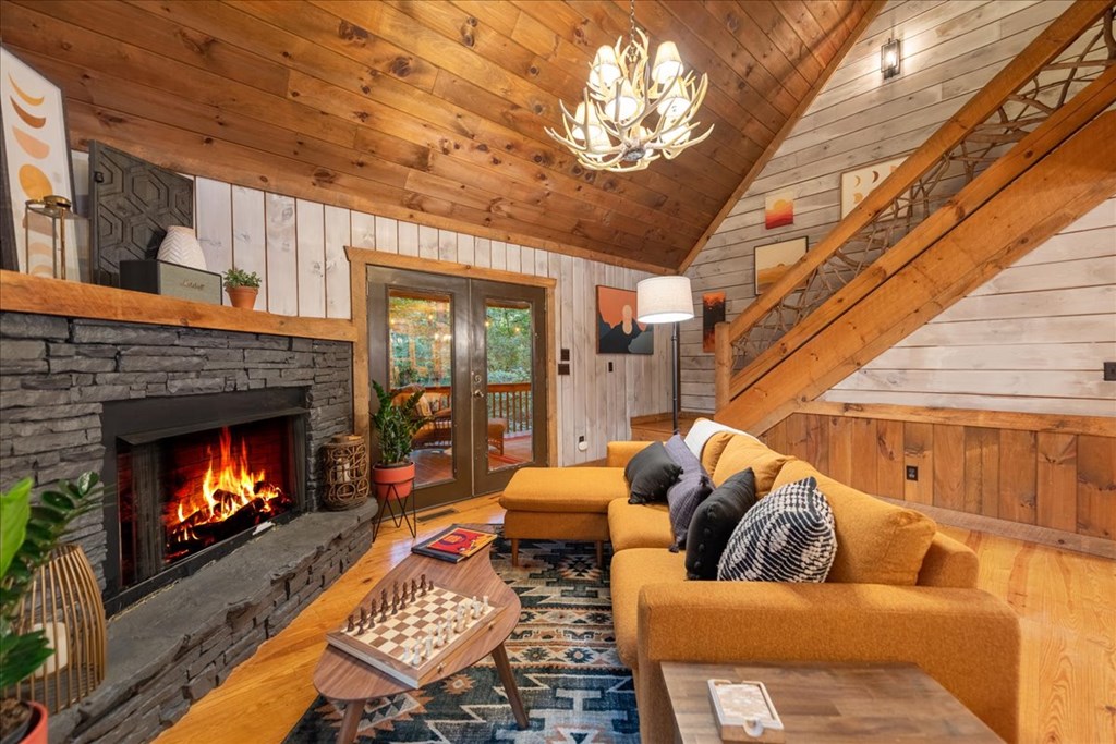 126 Brookwood Drive Blue Ridge, GA 30513 - Photo 40 of 84 a living room with furniture a fireplace and a flat screen tv