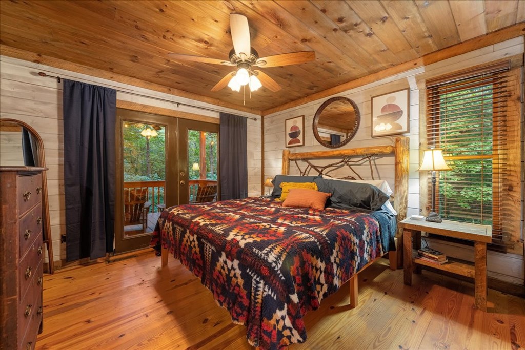 126 Brookwood Drive Blue Ridge, GA 30513 - Photo 44 of 84 a bedroom with a bed a dresser next to a window