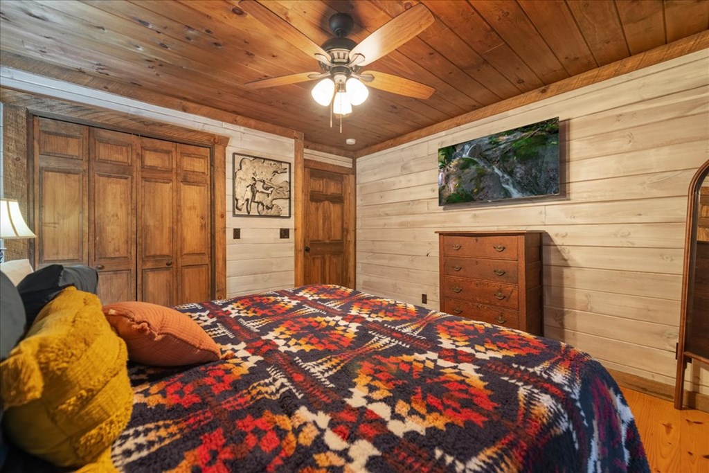 126 Brookwood Drive Blue Ridge, GA 30513 - Photo 45 of 84 a bedroom with a bed and a ceiling fan