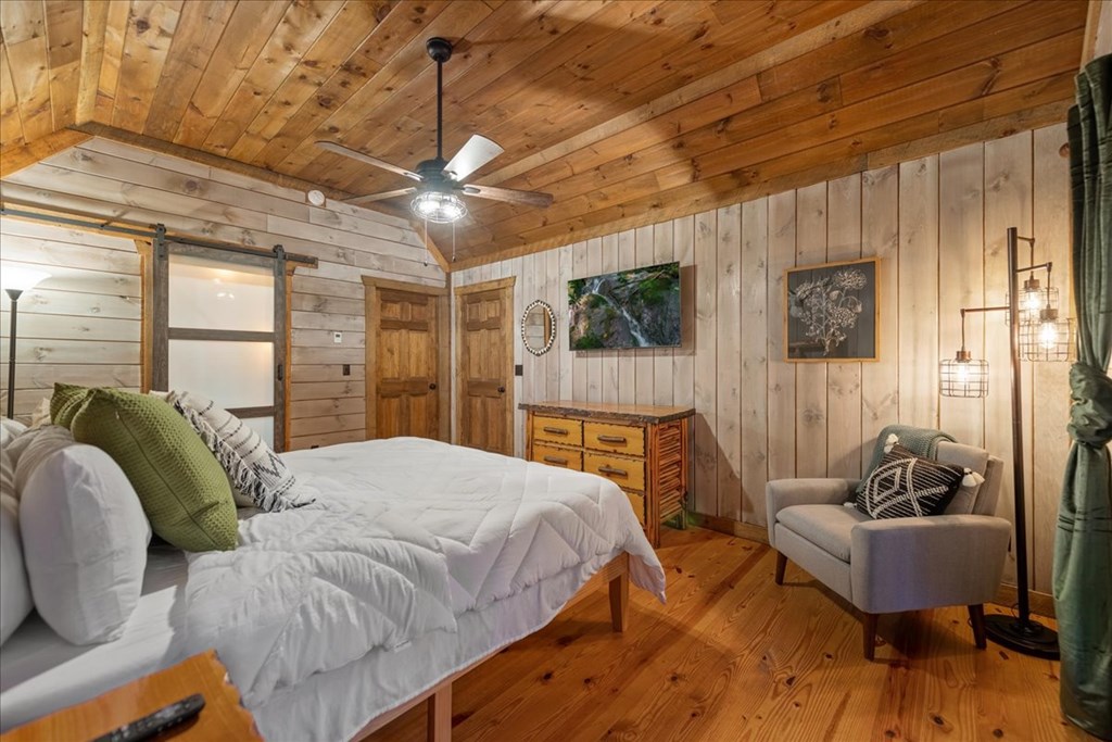 126 Brookwood Drive Blue Ridge, GA 30513 - Photo 55 of 84 a bedroom with a bed and a chandelier