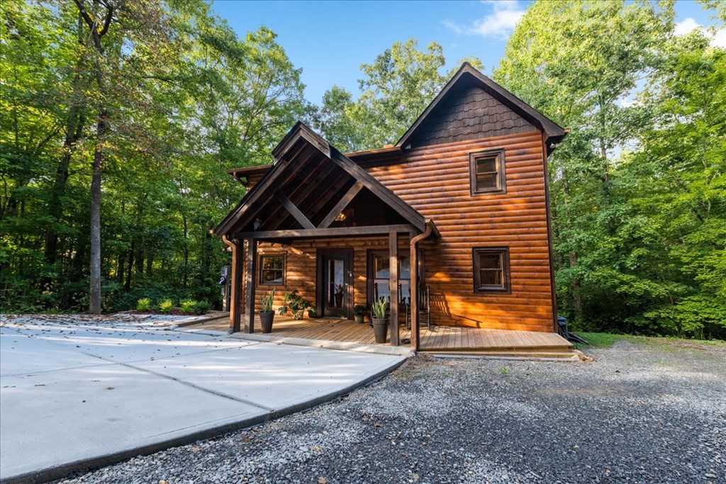 126 Brookwood Drive Blue Ridge, GA 30513 - Photo 7 of 84 a view of a house with large trees and wooden fence