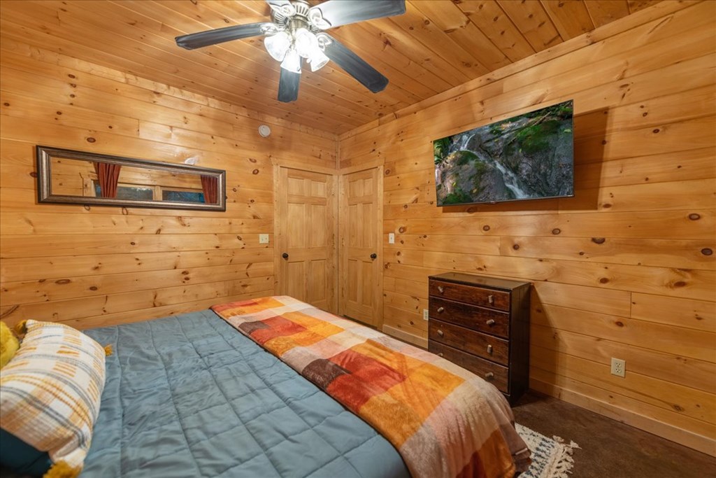 126 Brookwood Drive Blue Ridge, GA 30513 - Photo 75 of 84 a bedroom with a bed and a flat screen tv