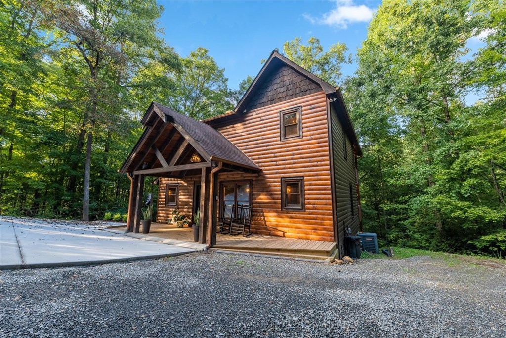 126 Brookwood Drive Blue Ridge, GA 30513 - Photo 8 of 84 a view of house with a yard and large trees