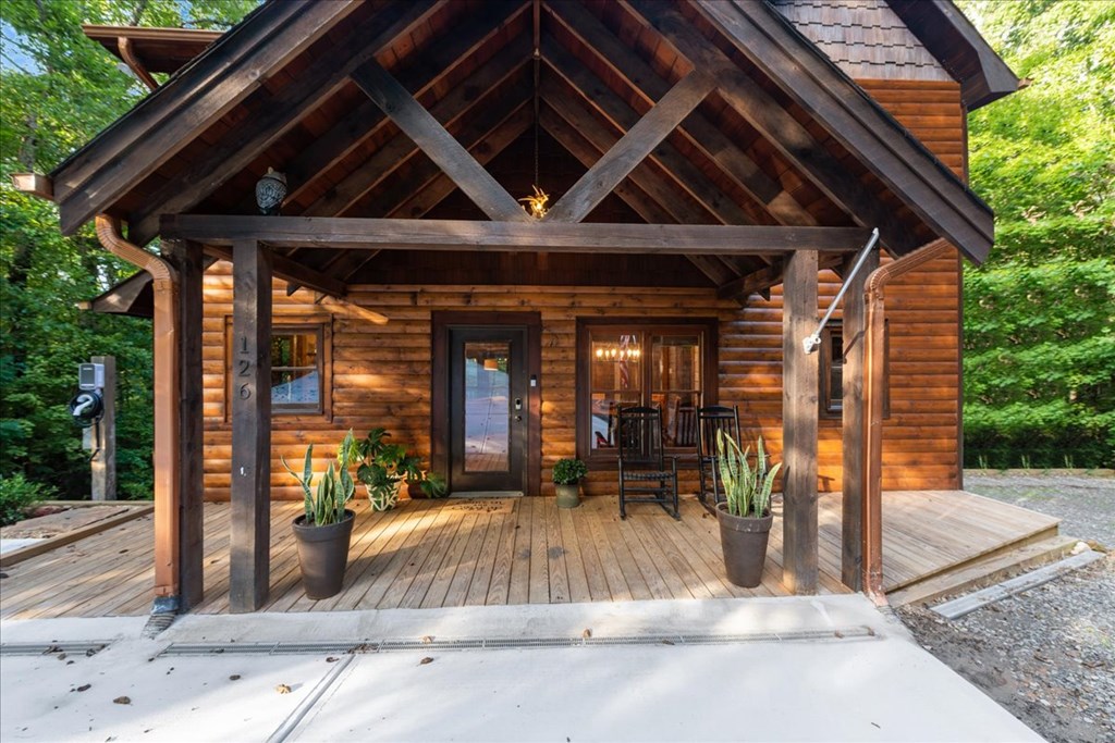126 Brookwood Drive Blue Ridge, GA 30513 - Photo 10 of 84 a view of a patio with table and chairs potted plants and floor to ceiling window