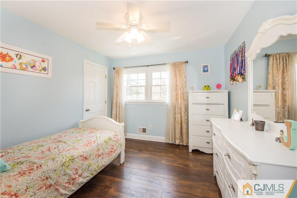 4 Peake Road Edison, NJ 08837 - Photo 14 of 25 a bedroom with a bed and a dresser