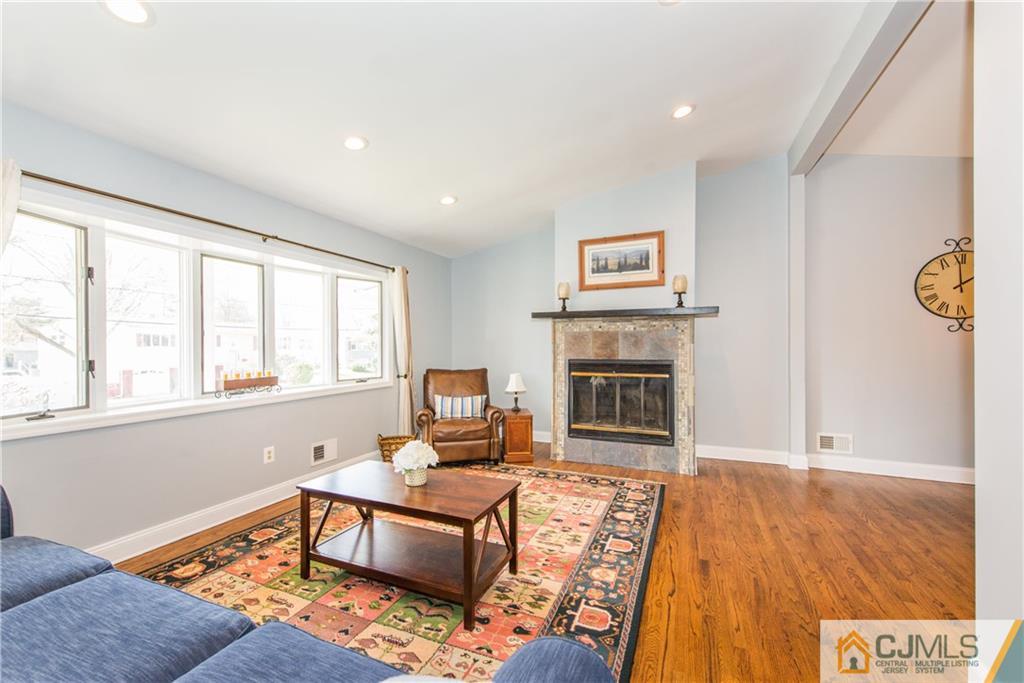 4 Peake Road Edison, NJ 08837 - Photo 4 of 25 a living room with furniture and a fireplace