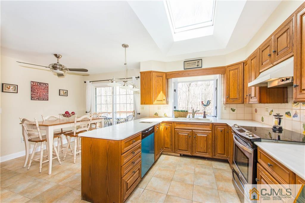 4 Peake Road Edison, NJ 08837 - Photo 10 of 25 a kitchen with a sink stove and cabinets