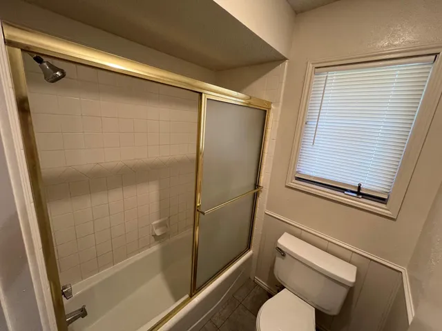 a bathroom with a shower and toilet