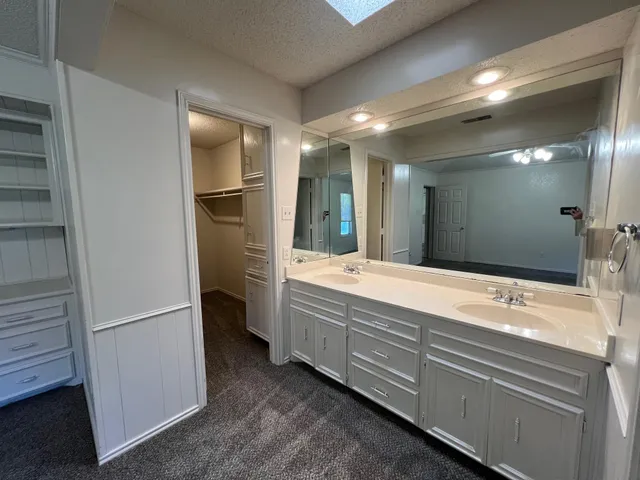 a bathroom with a double vanity sink and mirror