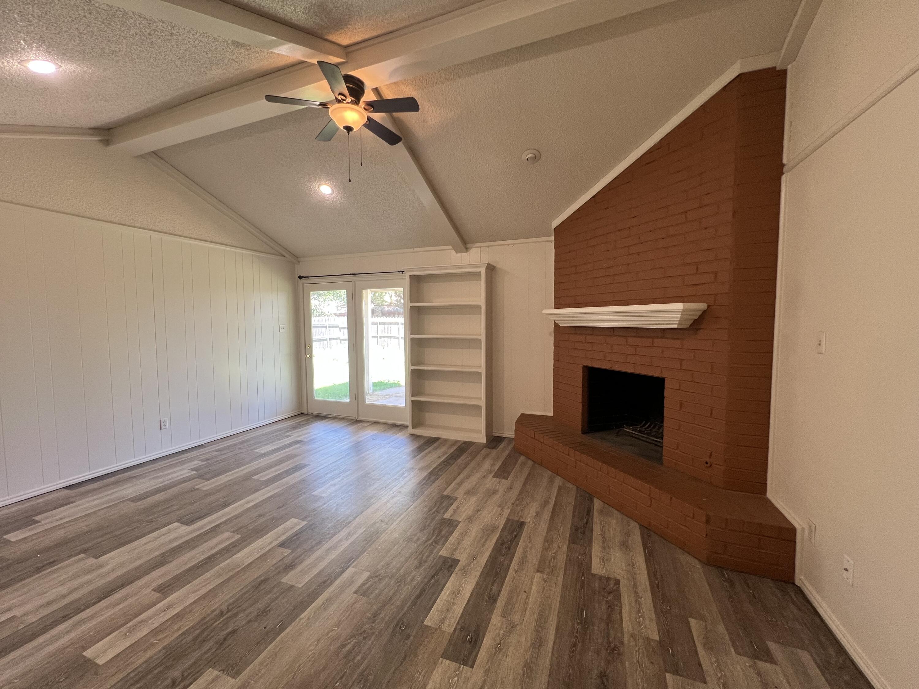 5522 95th Street Lubbock, TX 79424 - Photo 5 of 26 a view of empty room with wooden floor and fan