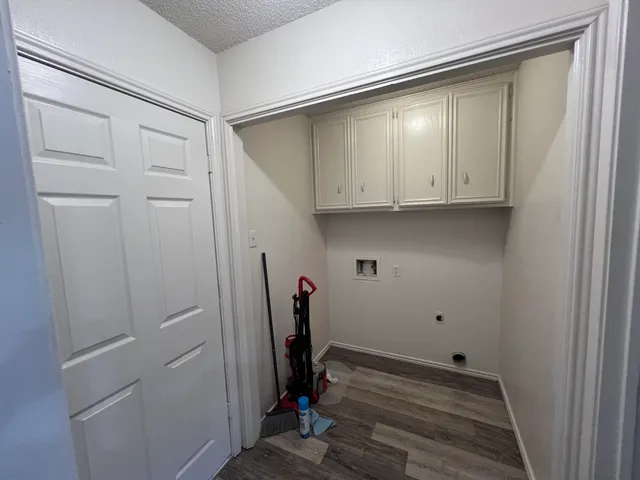 a view of storage and utility room with wooden floor
