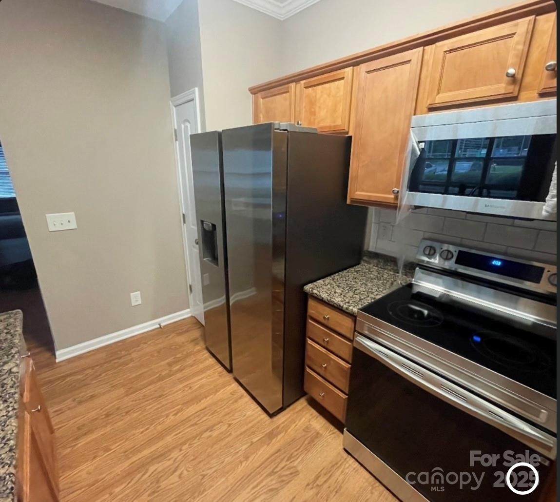 5430 Forester Drive High Point, NC 27265 - Photo 11 of 21 a kitchen with a refrigerator and a stove