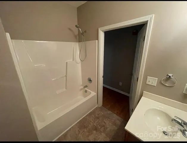 a bathroom with a tub and a shower
