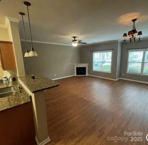 a view of a kitchen with a sink cabinets and wooden floor