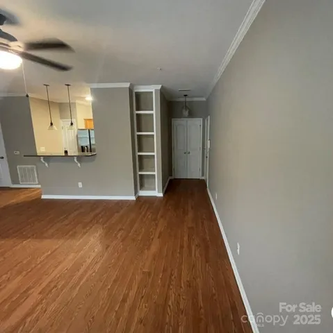 a view of a room with wooden floor and closet