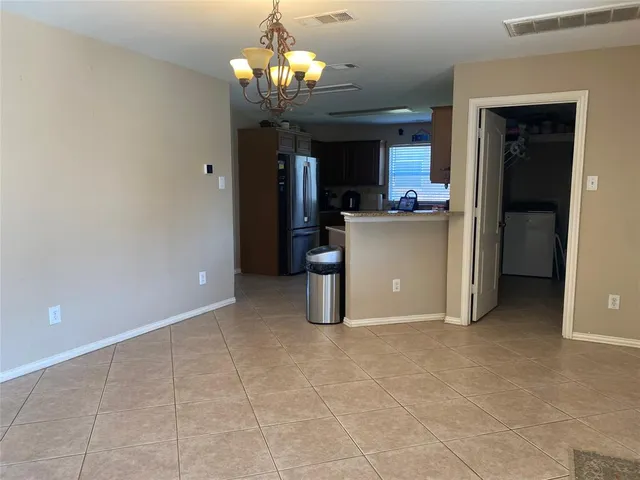 a view of a chandelier and a chandelier fan in a room