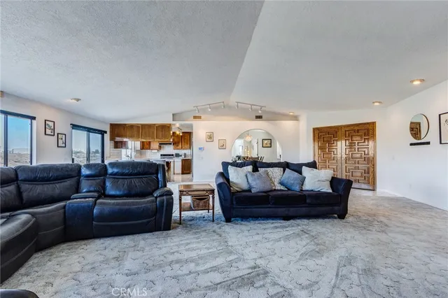 a view of a dining room with a table and chairs