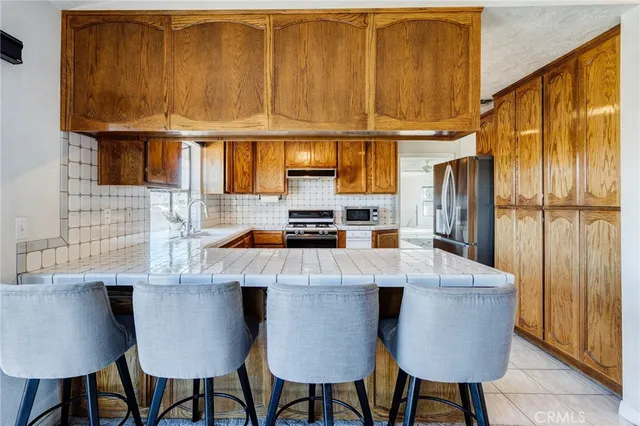 a living room with furniture a chandelier and a fireplace