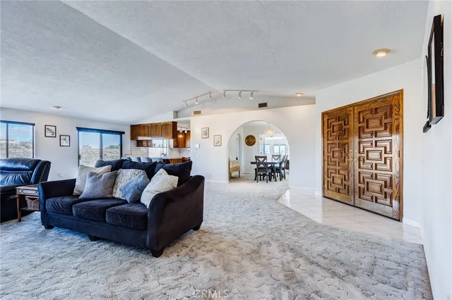 a view of a livingroom with workspace and a window