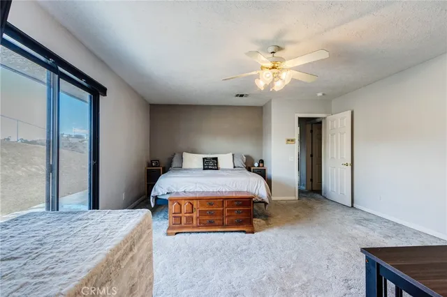 a patio with table and chairs and potted plants