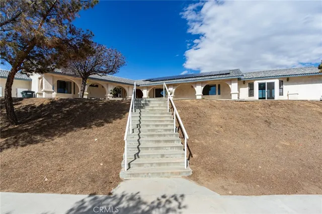 a front view of a house with a yard outdoor seating and garage