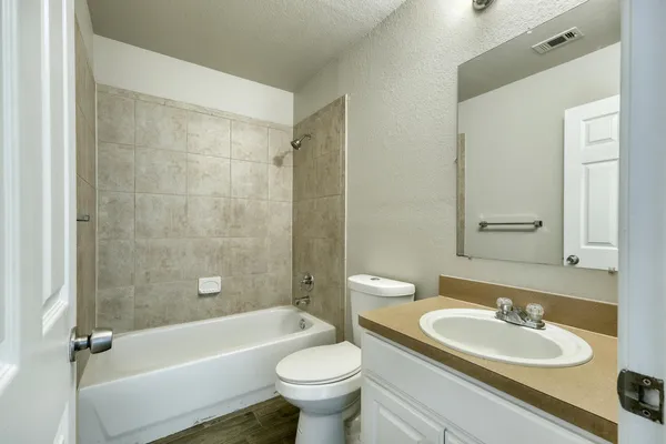 a bathroom with a sink a toilet and a mirror