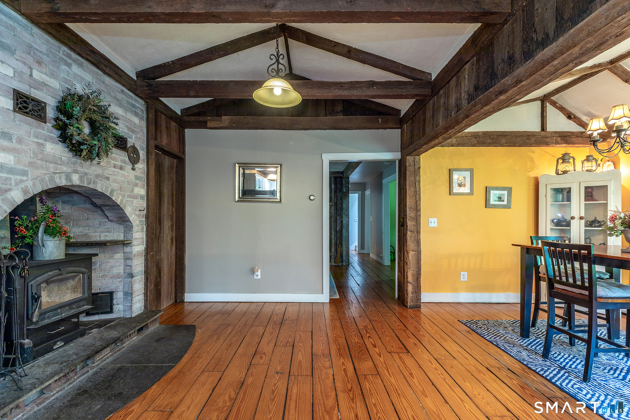 25 Bald Hill Road Kent, CT 06785 - Photo 9 of 38 Cozy Stone Alcove with Wood-Burning Stove A, rustic stone alcove beautifully showcases a wood-burning stove. The thick stone acts as a natural thermal mass, absorbing heat from the roaring fire & slowly radiating warmth into the room.