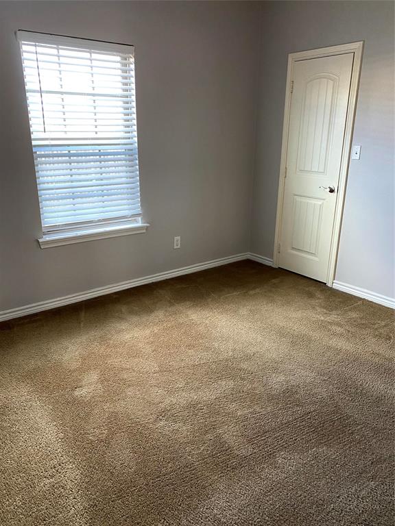 906 Parkplace Ridge Princeton, TX 75407 - Photo 25 of 31 Neutral wall finishes complementing a brown carpeted floor