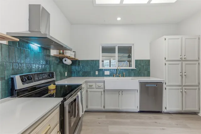 a kitchen that has a sink and a stove