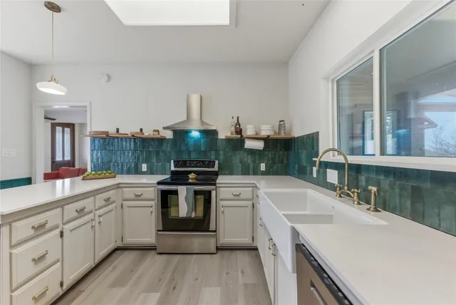 a kitchen with a sink stove and cabinets
