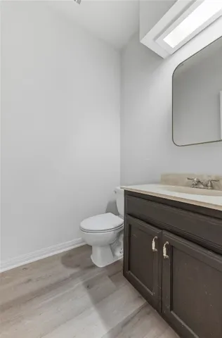a bathroom with a toilet a sink and mirror