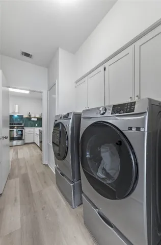 a utility room with sink dryer and washer