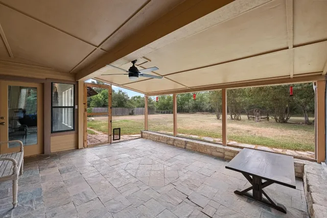 a view of a porch with chairs and backyard