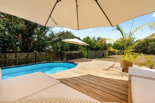 a view of a house with wooden deck