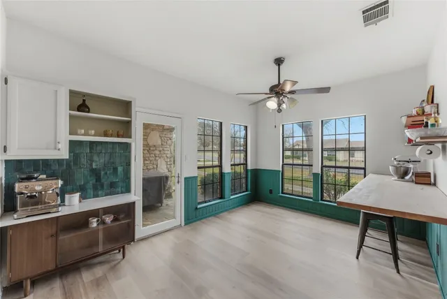 a view of a livingroom with furniture cabinet and window