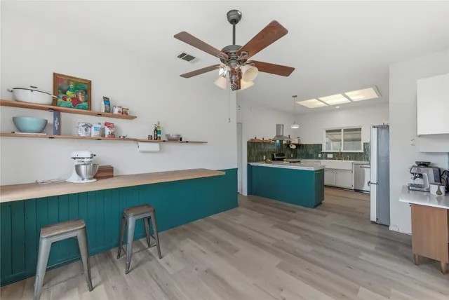 a kitchen with a cabinets and wooden floor