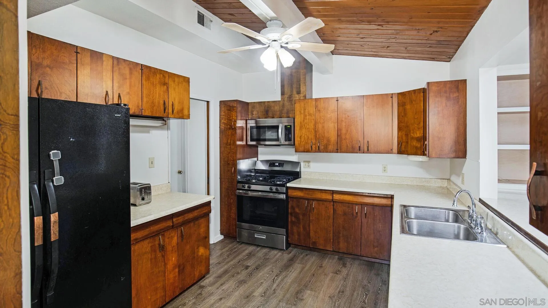 9243 Los Coches Road Lakeside, CA 92040 - Photo 11 of 30 a kitchen with stainless steel appliances granite countertop a refrigerator a stove and a sink