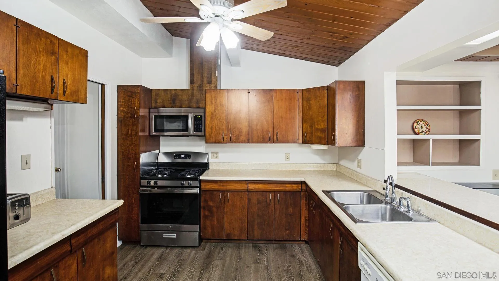 9243 Los Coches Road Lakeside, CA 92040 - Photo 12 of 30 a kitchen with a sink stove and refrigerator