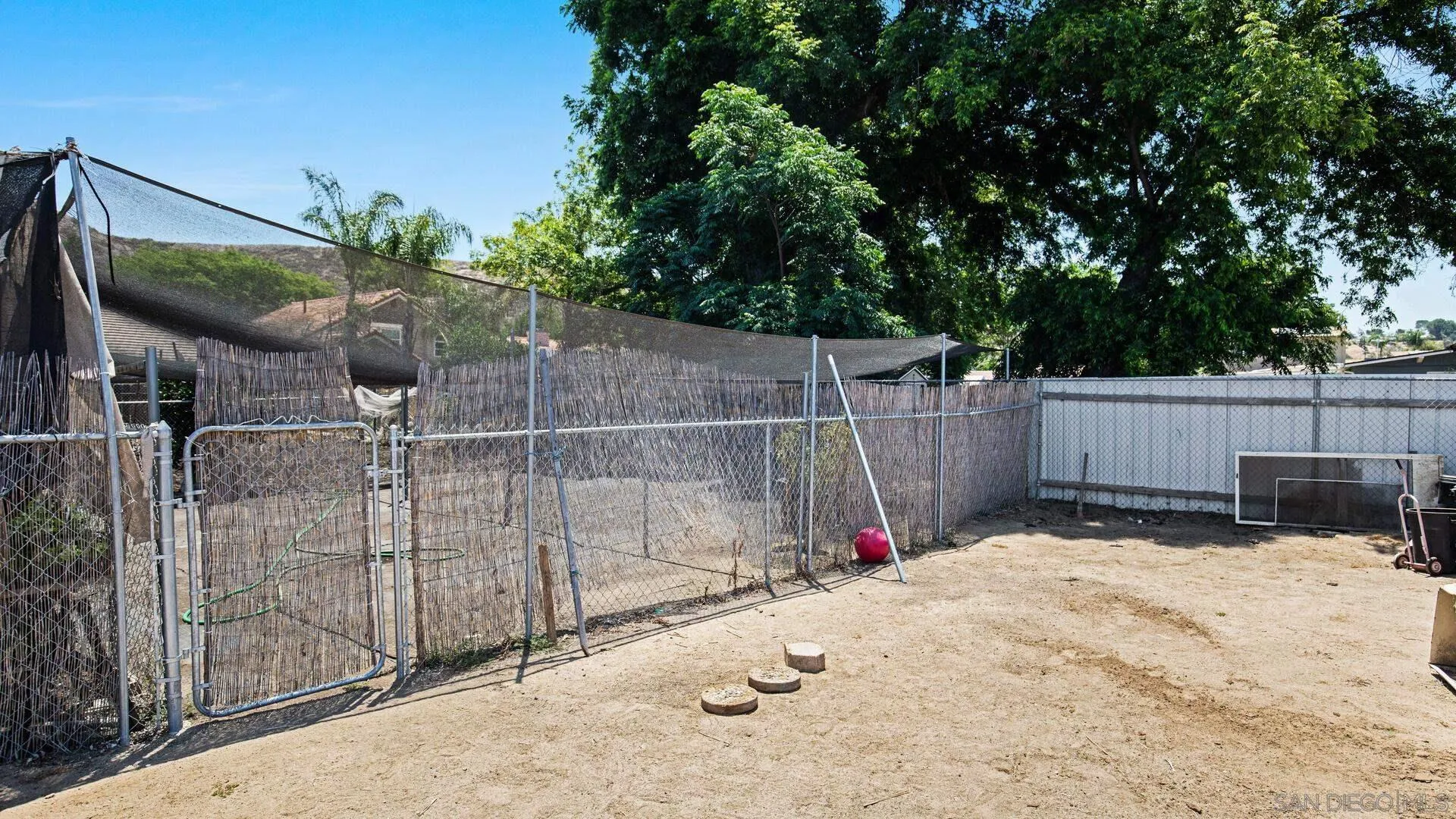 9243 Los Coches Road Lakeside, CA 92040 - Photo 22 of 30 a view of backyard with wooden fence and a large tree