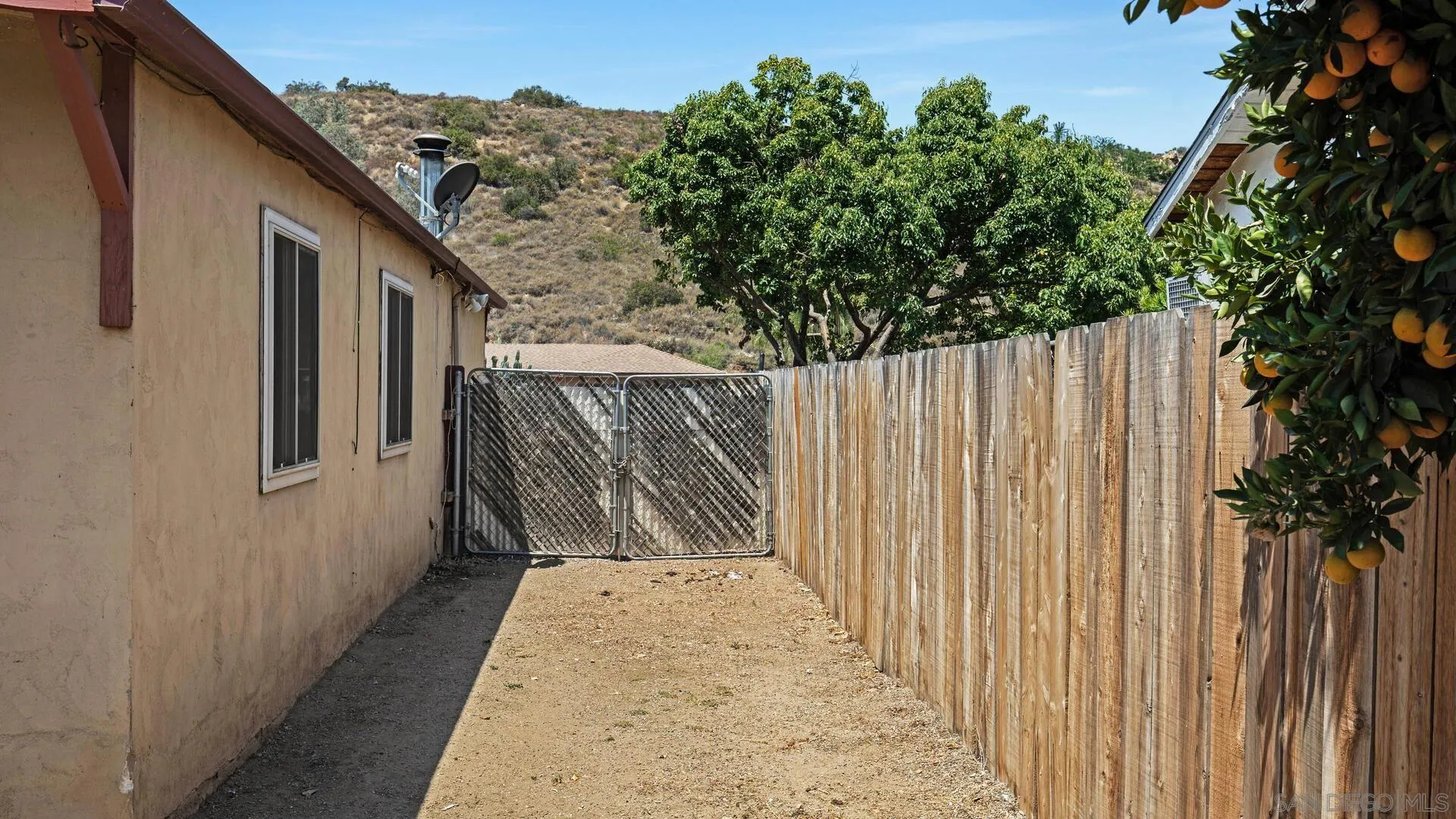 9243 Los Coches Road Lakeside, CA 92040 - Photo 23 of 30 a view of a wooden door with a house in the background