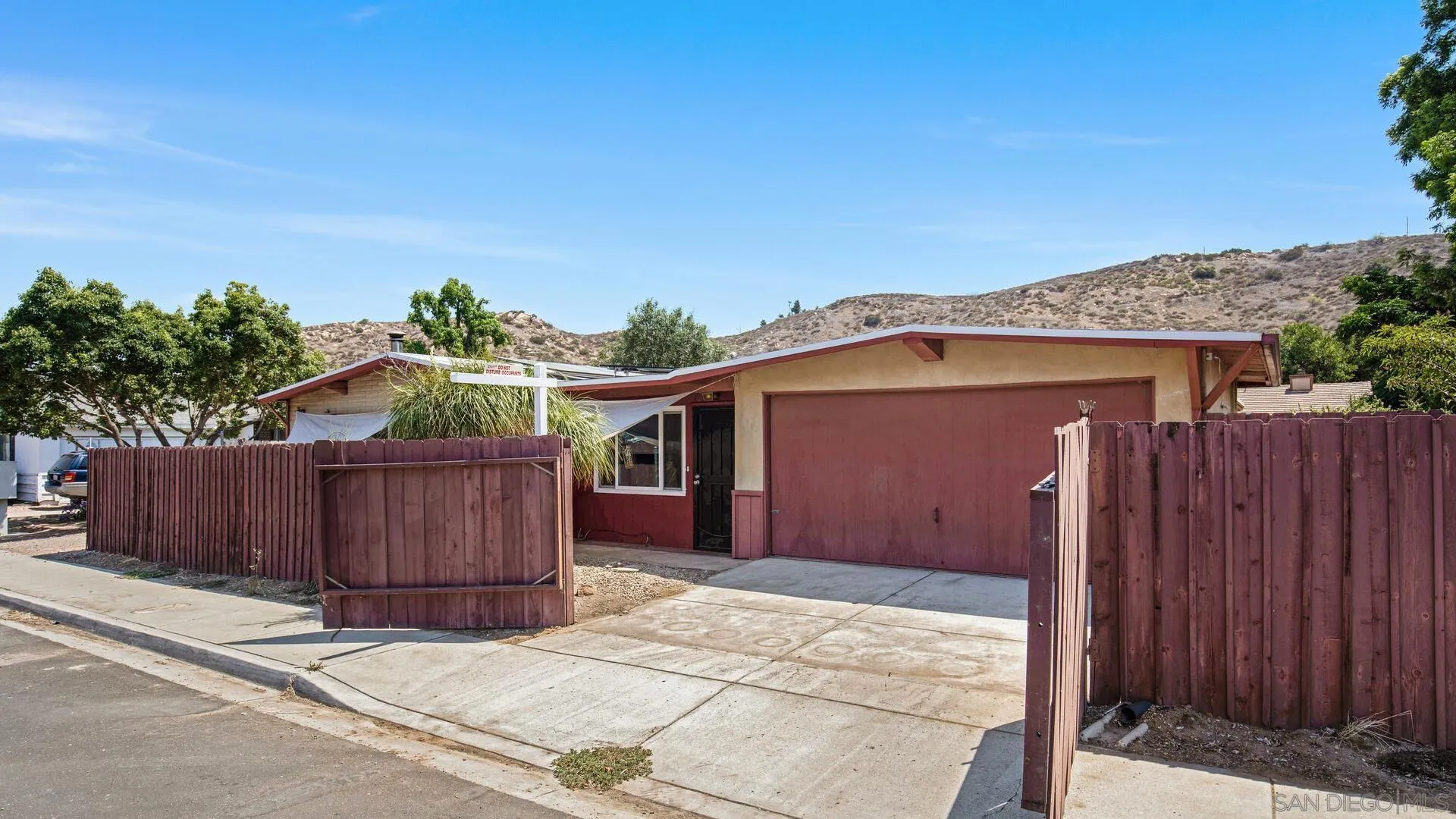 9243 Los Coches Road Lakeside, CA 92040 - Photo 7 of 30 a view of a house with wooden fence